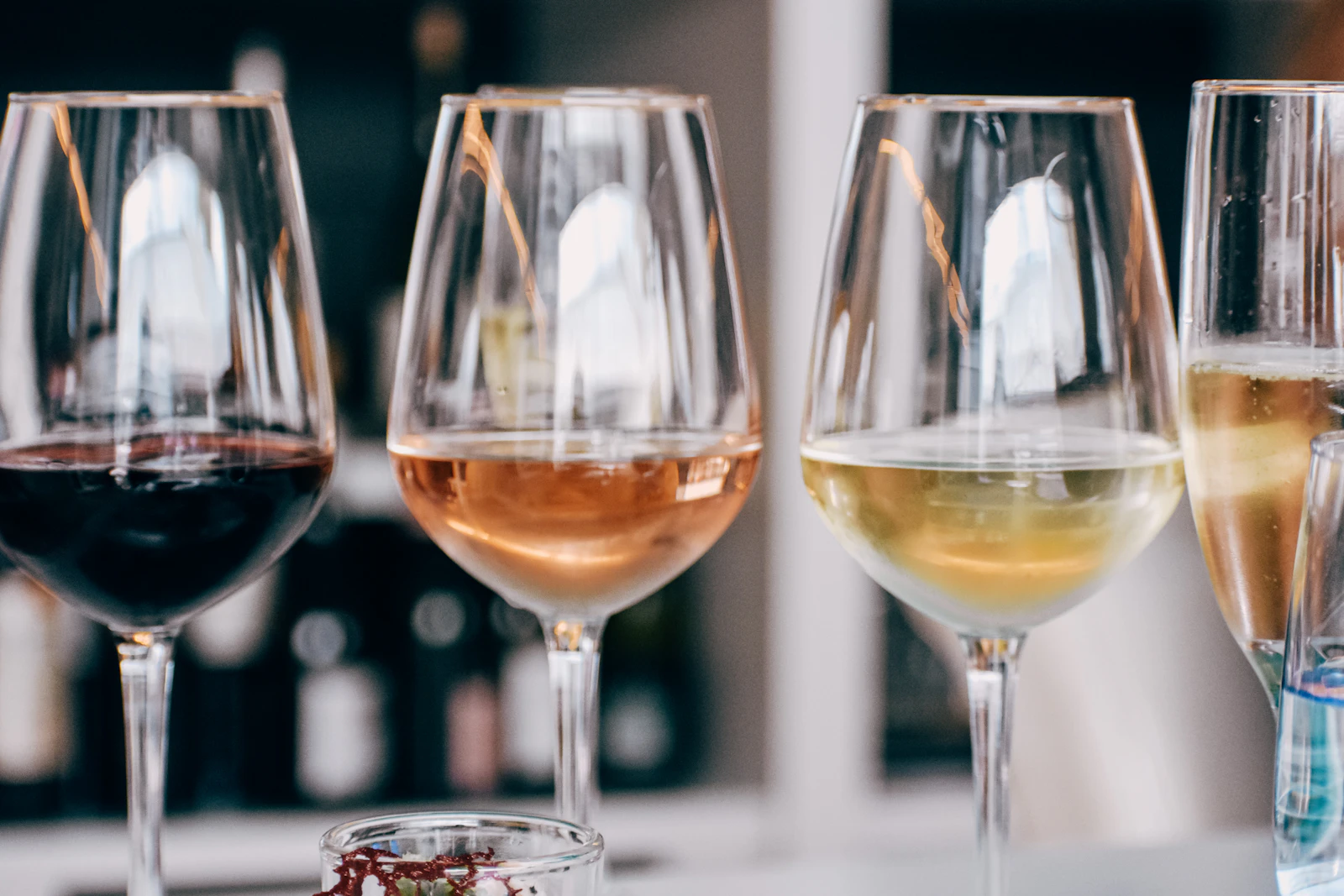 Glasses of red, rosé and white wine on a table
